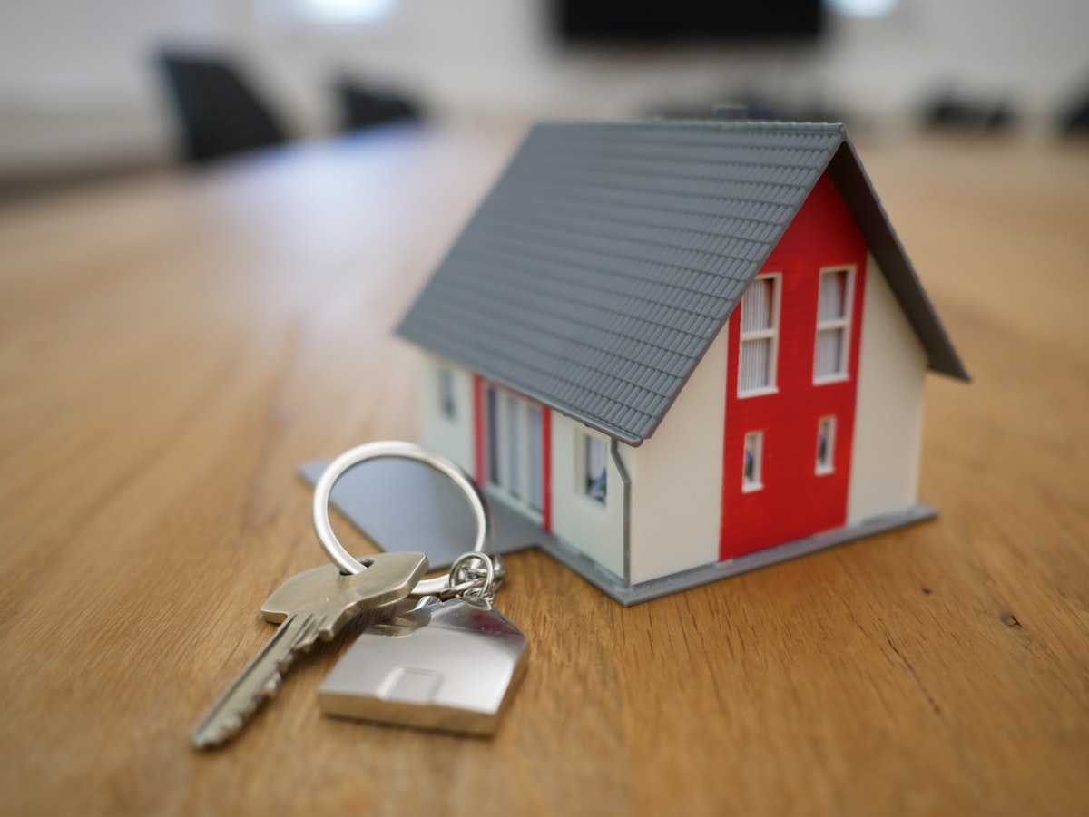 Real estate agent handing house keys to home buyer at closing